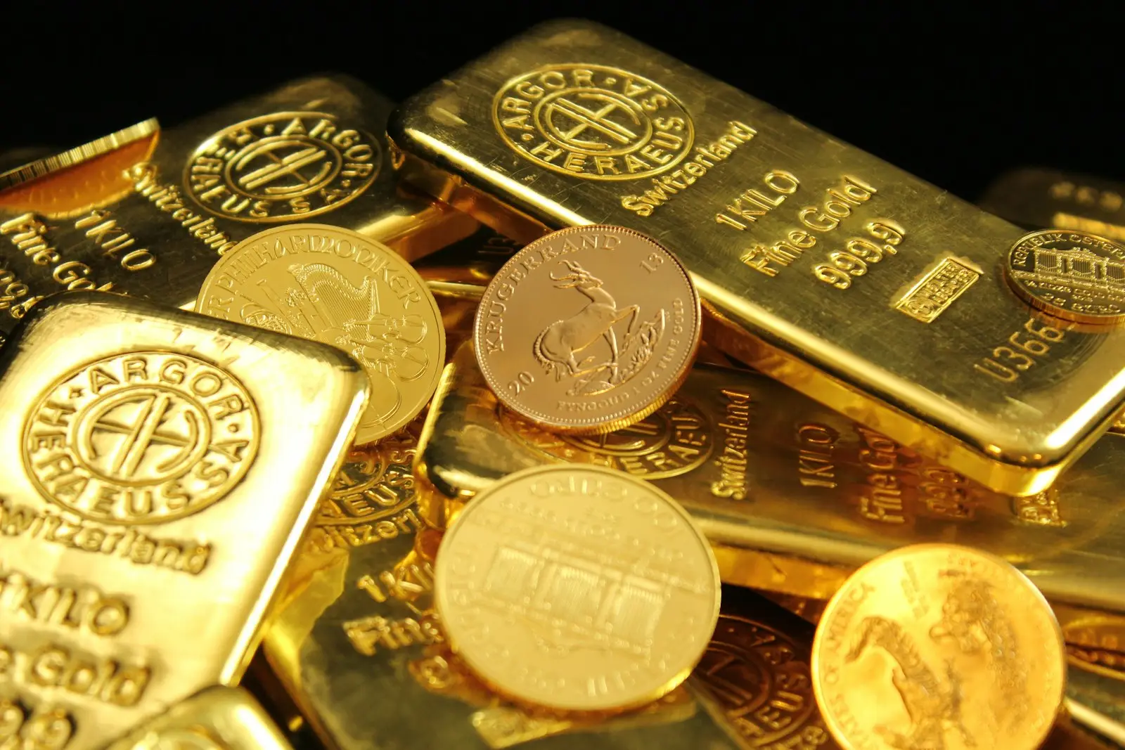 Gold bars stacked with gold coins